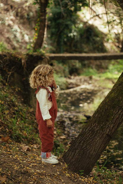 Kid playing; overalls; jumpsuit; dungaree