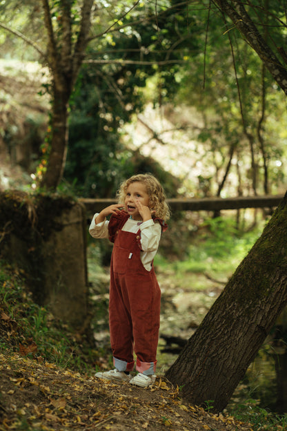 Kid playing; overalls; jumpsuit; dungaree