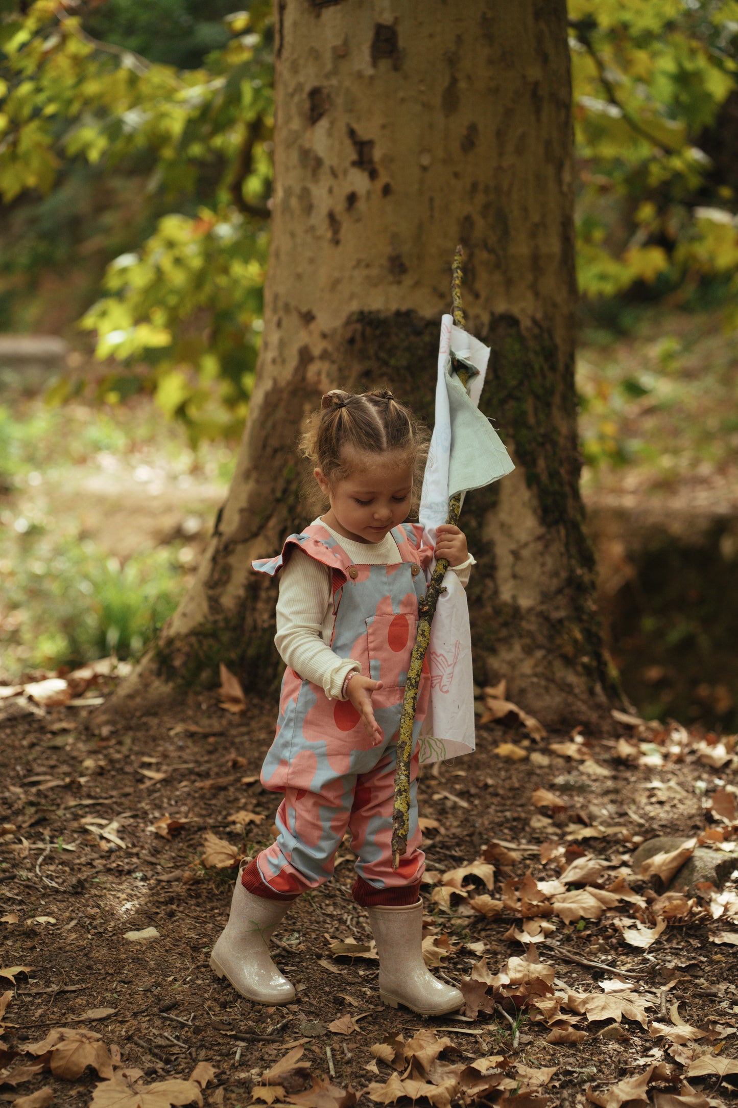 Kid playing; overalls; jumpsuit; dungaree