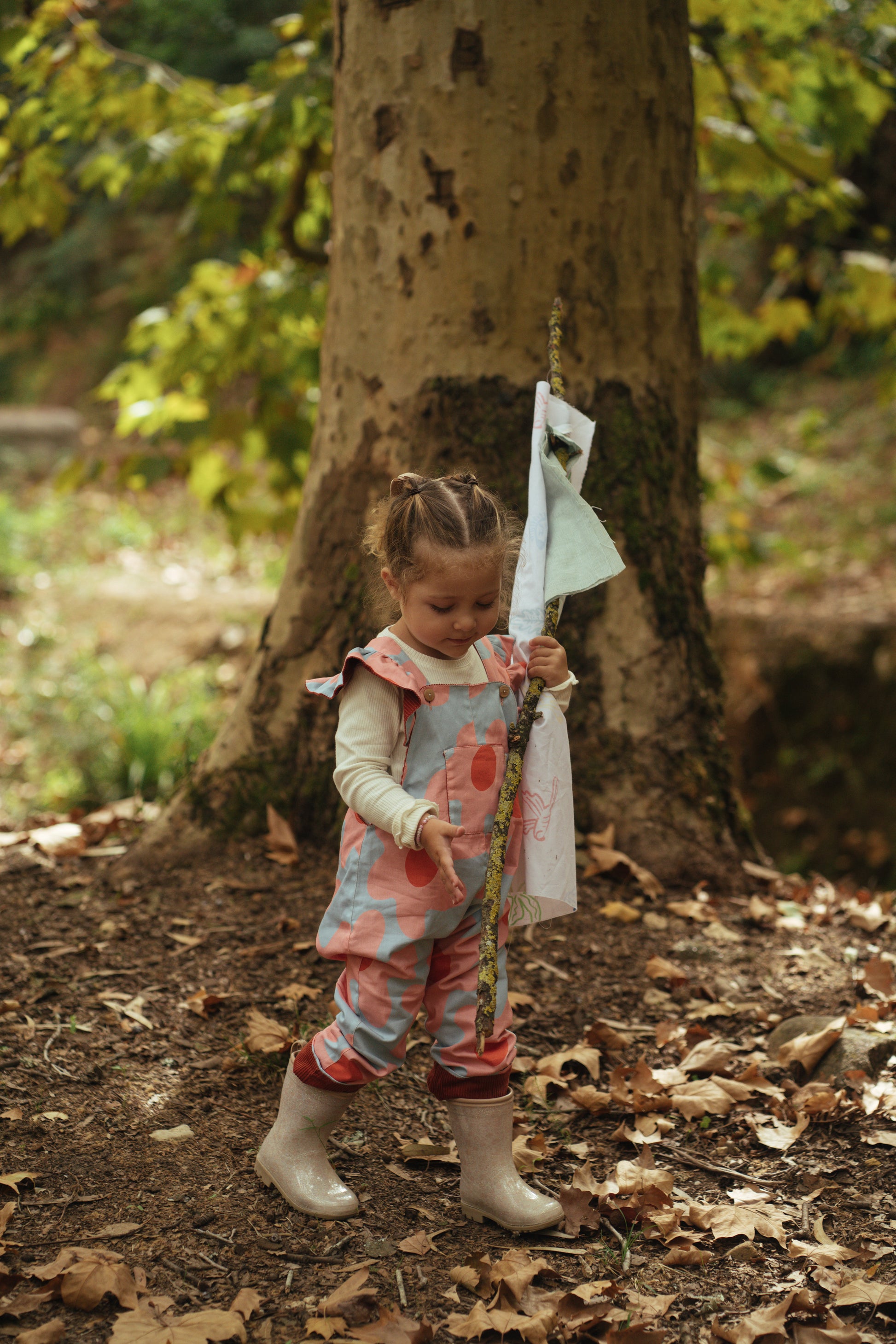 Kid playing; overalls; jumpsuit; dungaree